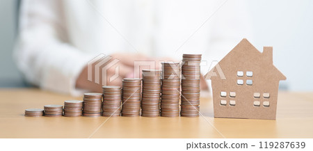 Money Saving, Property investment, House Mortgage and Real Estate Financial concepts. coins stack with Home model, Money stack Counting arrangement for deposit and Tax 119287639