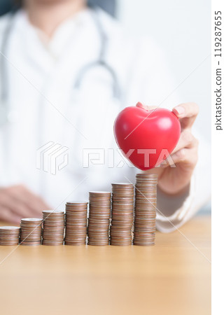 Money Saving, Health Insurance, Medical, Donation and Financial concepts. Doctor with coins stack and Heart on table. Money stack Counting arrangement for deposit and Healthcare cost 119287655