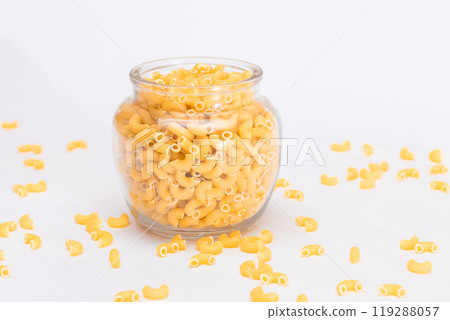 Uncooked Chifferi Rigati Pasta in Glass Jar on White Background Uncooked Chifferi Rigati Pasta in Glass Jar on White Background 119288057