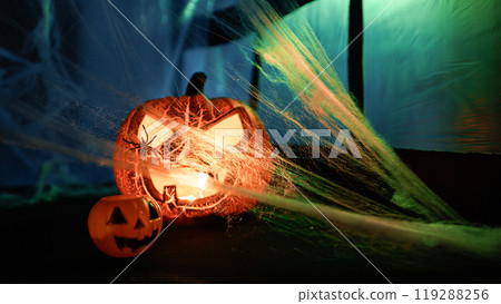 Spiderweb Blowing In The Wind And Illuminating Halloween Pumpkin 119288256