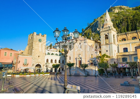 Square Piazza IX Aprile with San Giuseppe church and Clock Tower in Taormina, Sicily, Italy. 119289145