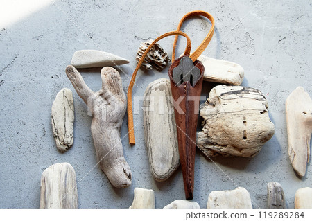 Jew's harp in a brown genuine leather case on a gray background. Sound therapy. Jew's harp in a brown genuine leather case on a gray background. Sound therapy. 119289284