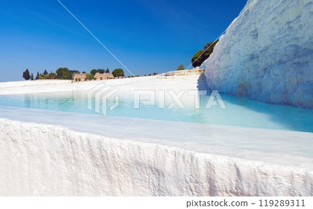 Pool with clear hot water from thermal spring in Pamukkale, Turkey. Pamukkale is most visited turkish travel attraction. Pool with clear hot water from thermal spring in Pamukkale, Turkey. Pamukkale is most visited turkish travel attraction. 119289311