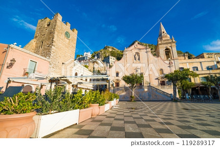 Square Piazza IX Aprile with San Giuseppe church and Clock Tower in Taormina, Sicily, Italy. 119289317