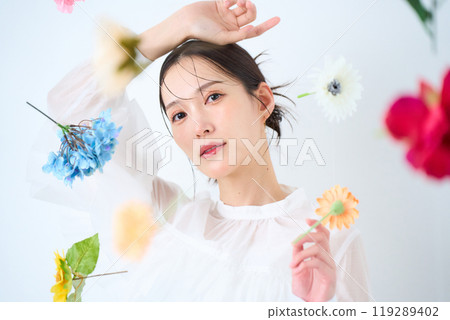 A woman surrounded by colorful flowers - fantasy 119289402