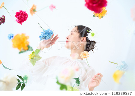 A woman surrounded by colorful flowers - fantasy 119289587