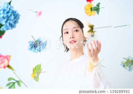 A woman surrounded by colorful flowers - fantasy A woman surrounded by colorful flowers - fantasy 119289591