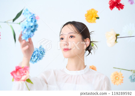 A woman surrounded by colorful flowers - fantasy A woman surrounded by colorful flowers - fantasy 119289592