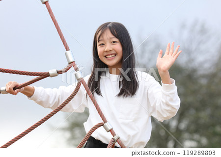 Girls playing in the park 119289803