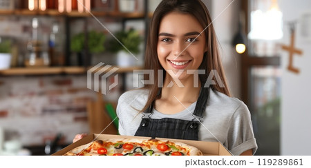 Young woman holding a pizza box 119289861