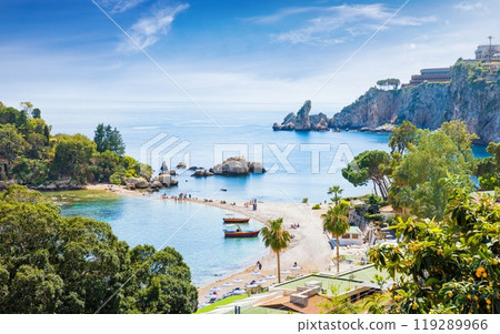 Beautiful Isola Bella, small island near Taormina, Sicily, Italy. Narrow path connects island to mainland Taormina beach surrounded by azure waters of Ionian Sea. 119289966