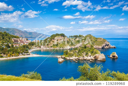 Beautiful Isola Bella, small island near Taormina, Sicily, Italy. Narrow path connects island to mainland Taormina beach surrounded by azure waters of Ionian Sea. 119289968
