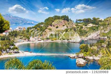 Beautiful Isola Bella, small island near Taormina, Sicily, Italy. Narrow path connects island to mainland Taormina beach surrounded by azure waters of Ionian Sea. Beautiful Isola Bella, small island near Taormina, Sicily, Italy. Narrow path connects island to mainland Taormina beach surrounded by azure waters of Ionian Sea. 119289969