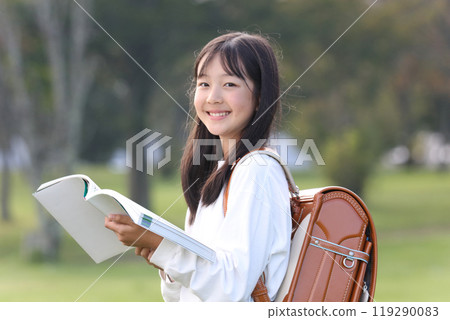 Elementary school student reading a book Elementary school student reading a book 119290083