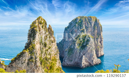 Famous Faraglioni Rocks near Capri Island, Italy. Beautiful paradise landscape with azure sea in summer sunny day. Famous Faraglioni Rocks near Capri Island, Italy. Beautiful paradise landscape with azure sea in summer sunny day. 119290137