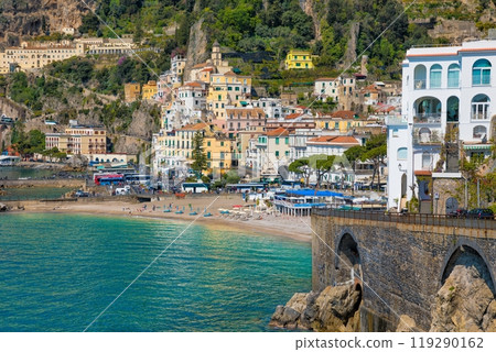 Beautiful Amalfi on hills leading down to coast, comfortable beaches and azure sea in Campania, Italy. Beautiful Amalfi on hills leading down to coast, comfortable beaches and azure sea in Campania, Italy. 119290162