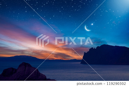 Ramadan background with crescent, stars and glowing clouds with ray from skies above mountains and sea. Month of Ramadan is that in which was revealed Quran. Ramadan background with crescent, stars and glowing clouds with ray from skies above mountains and sea. Month of Ramadan is that in which was revealed Quran. 119290302