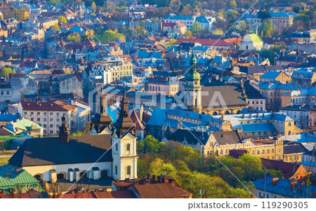 Aerial sunset view of historical old city district with churches, cathedrals and houses roofs in Lviv, Ukraine. Aerial sunset view of historical old city district with churches, cathedrals and houses roofs in Lviv, Ukraine. 119290305