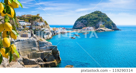 Rocky coast of Sant'Angelo, giant green rock in blue sea near Ischia Island, Italy. Sant'Angelo is small village within comune of Serrara Fontana, Ischia. 119290314