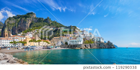 Beautiful Amalfi with hotels on hills leading down to coast, comfortable beaches and azure sea in Campania, Italy. Beautiful Amalfi with hotels on hills leading down to coast, comfortable beaches and azure sea in Campania, Italy. 119290338