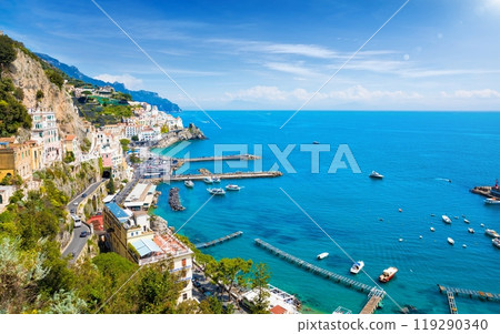 Beautiful Amalfi with hotels on hills leading down to coast, comfortable beaches and azure sea in Campania, Italy. Beautiful Amalfi with hotels on hills leading down to coast, comfortable beaches and azure sea in Campania, Italy. 119290340
