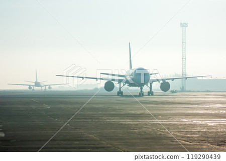 Passenger airplanes in the fog on the airport 119290439
