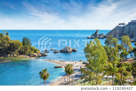 Beautiful Isola Bella, small island near Taormina, Sicily, Italy. Narrow path connects island to mainland Taormina beach surrounded by azure waters of Ionian Sea. 119290487