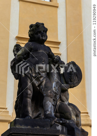Baroque statue before facade Loreta Monastery in Prague, Czech Republic 119290949