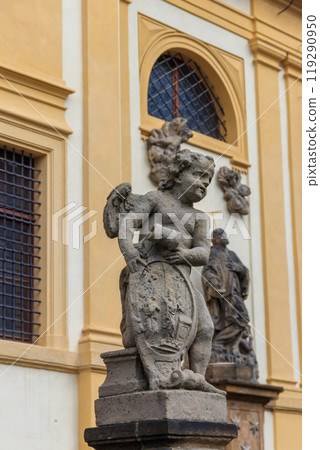 Baroque statue before facade Loreta Monastery in Prague, Czech Republic 119290950