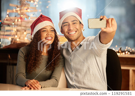 Couple, phone and selfie for Christmas, celebration and party or work event in office together. Man, woman and smartphone for social media, happiness and memory at night while on vacation or holiday Couple, phone and selfie for Christmas, celebration and party or work event in office together. Man, woman and smartphone for social media, happiness and memory at night while on vacation or holiday 119291581