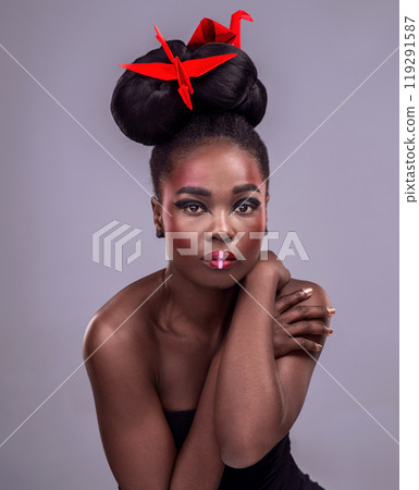Female model, studio and portrait with oriental origami for beauty, traditional or creative cosmetics. Black woman, gray background and paper design with makeup or color for art, culture or craft Female model, studio and portrait with oriental origami for beauty, traditional or creative cosmetics. Black woman, gray background and paper design with makeup or color for art, culture or craft 119291587