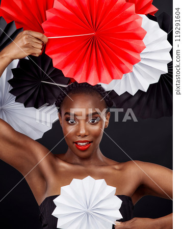 Beauty, origami fans and portrait of African woman with art deco by dark background. Creative makeup, cosmetics and Black female model with oriental craft, paper and aesthetic on studio backdrop Beauty, origami fans and portrait of African woman with art deco by dark background. Creative makeup, cosmetics and Black female model with oriental craft, paper and aesthetic on studio backdrop 119291604