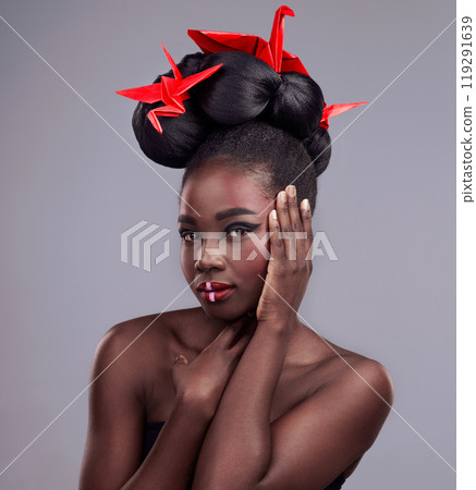 Black woman, studio and portrait with origami for beauty, traditional or creative with cosmetics. Female model, gray background and oriental paper design with makeup or color for culture and art Black woman, studio and portrait with origami for beauty, traditional or creative with cosmetics. Female model, gray background and oriental paper design with makeup or color for culture and art 119291639