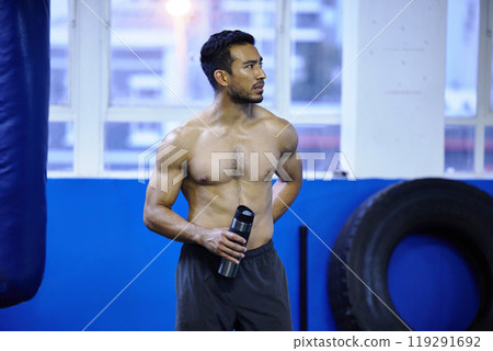 Man, athlete and drinking water at gym, thirsty and hydration after workout or strength training. Male person, detox and mineral liquid for recovery after exercise, fitness and boxer or shirtless Man, athlete and drinking water at gym, thirsty and hydration after workout or strength training. Male person, detox and mineral liquid for recovery after exercise, fitness and boxer or shirtless 119291692