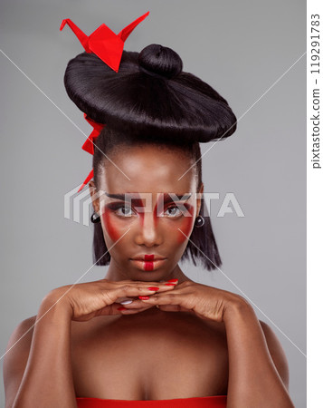 Creative beauty, portrait and black woman with origami in studio isolated on dark background. Serious face, makeup and skincare with African female, traditional and Japanese paper art for cosmetics Creative beauty, portrait and black woman with origami in studio isolated on dark background. Serious face, makeup and skincare with African female, traditional and Japanese paper art for cosmetics 119291783