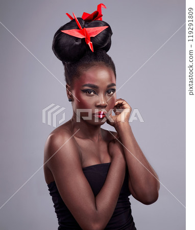Woman, face makeup and origami in studio for beauty with red color, Oriental culture and paper bird. African model, bold cosmetics and grey background for art deco, confidence and creative design Woman, face makeup and origami in studio for beauty with red color, Oriental culture and paper bird. African model, bold cosmetics and grey background for art deco, confidence and creative design 119291809