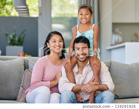 Portrait, parents and asian child on sofa with smile, bonding and relax together in living room on weekend. Mom, dad and girl on shoulders with love, trust and support in modern home in Indonesia. Portrait, parents and asian child on sofa with smile, bonding and relax together in living room on weekend. Mom, dad and girl on shoulders with love, trust and support in modern home in Indonesia. 119291926