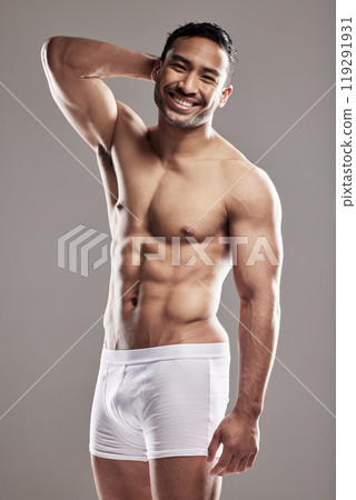 Portrait, man and smile for fitness in health, wellness and underwear, body and sexy in studio background. Male person, confident and strong for pride as model for happiness in grey backdrop Portrait, man and smile for fitness in health, wellness and underwear, body and sexy in studio background. Male person, confident and strong for pride as model for happiness in grey backdrop 119291931