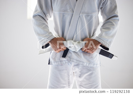 Man, closeup or belt for martial arts sport in fitness center for self defense, fighting or discipline. Pro athlete, jiu-jitsu and hands on uniform for training, practice or wellness for competition 119292138