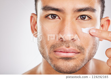 Asian man, portrait or face cream for beauty in studio with smile, natural cosmetics or glow for shine. Dermatology, antiaging treatment or model applying skincare lotion or creme on white background Asian man, portrait or face cream for beauty in studio with smile, natural cosmetics or glow for shine. Dermatology, antiaging treatment or model applying skincare lotion or creme on white background 119292165