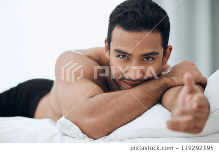 Happy, man and hand for welcome to bed in morning with blankets and pillows for romance or intimacy at home. Asian male person and model with smile, confidence and sexy greeting or gesture in bedroom 119292195