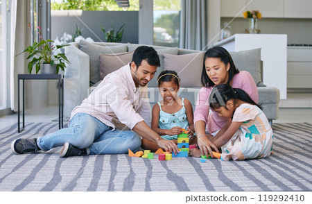 Mother, father and children playing with building blocks in home on living room carpet, support or bonding. Man, woman and daughter for family connection with development games, education or learning 119292410