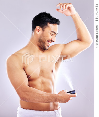 Man, grooming and smile with deodorant in studio background for hygiene, cleanliness and wellness. Male person, happy and confident with spray for odor, fragrance and body freshness or health Man, grooming and smile with deodorant in studio background for hygiene, cleanliness and wellness. Male person, happy and confident with spray for odor, fragrance and body freshness or health 119292613