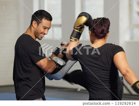 Boxer, woman and trainer with boxing gloves for fight workout of muay thai exercise. Fitness coach, self defence and sport pads for strength and power training in gym with cardio and instructor Boxer, woman and trainer with boxing gloves for fight workout of muay thai exercise. Fitness coach, self defence and sport pads for strength and power training in gym with cardio and instructor 119292614