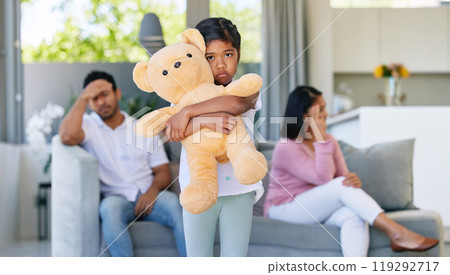 Couple, fighting and sad in child home, living room and girl with teddy bear for support and comfort in family conflict. Parents, divorce and marriage problems, childhood trauma and disagreement 119292717