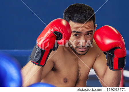 Man, athlete and fighting with gloves in ring for training, workout and practice for boxing competition. Boxer, pro champion and serious with sport for self defense, topless and healthy body in gym 119292771