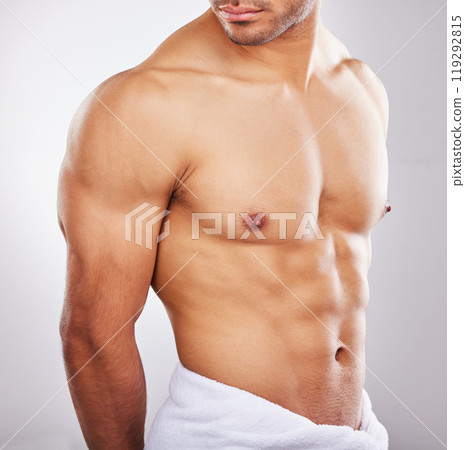Abs, towel and fitness in studio, person and health of body with workout, exercise and gym. Sports, athlete and bodybuilder with muscle, strong and wellness for abdomen, model and white background 119292815