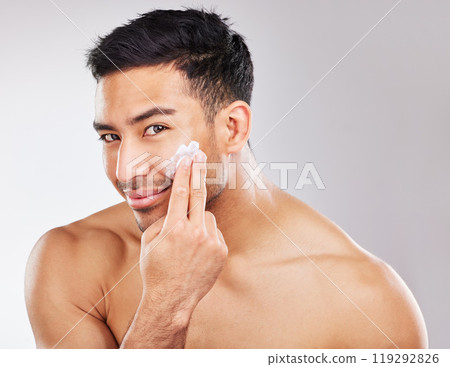 Face, portrait and man with lotion in studio background for skin hydration, anti aging and collagen. Moisturizer, male model and skincare with cosmetics for smooth, glowing or soft texture with pride Face, portrait and man with lotion in studio background for skin hydration, anti aging and collagen. Moisturizer, male model and skincare with cosmetics for smooth, glowing or soft texture with pride 119292826
