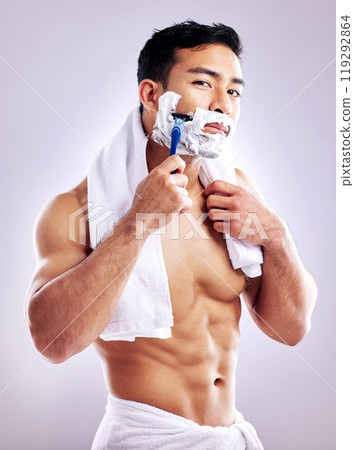 Body, portrait and man shaving face in studio for cleaning, health and hair removal for hygiene isolated on white background. Cream, shirtless and razor on beard for skincare, grooming or muscle Body, portrait and man shaving face in studio for cleaning, health and hair removal for hygiene isolated on white background. Cream, shirtless and razor on beard for skincare, grooming or muscle 119292864