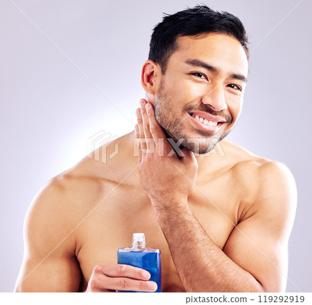 Model, smile and aftershave for face, grooming and beard for beauty and aesthetic wellness for healthy skin on studio background. Happy, guy and man for facial hair or dermatology, body and cosmetics 119292919